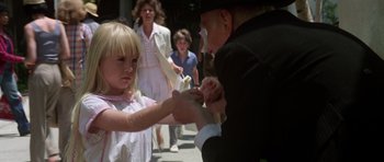 Movie still from “Poltergeist II: The Other Side” (1986), directed by Brian Gibson – An old man and a little girl on the street; Close Up shot, Over the shoulder angle