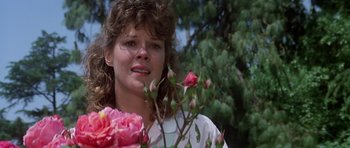 Movie still from “Poltergeist II: The Other Side” (1986), directed by Brian Gibson – A person holding a flower; Close Up shot, Low angle