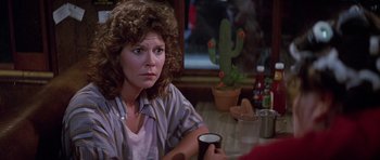 Movie still from “Poltergeist II: The Other Side” (1986), directed by Brian Gibson – A woman sitting at a table holding a coffee mug; Close Up shot, Over the shoulder angle