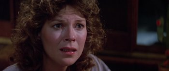 Movie still from “Poltergeist II: The Other Side” (1986), directed by Brian Gibson – A person with curly brown hair; Close Up shot, Low angle