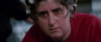 Movie still from “Poltergeist II: The Other Side” (1986), directed by Brian Gibson – A person wearing a red shirt; Close Up shot, Over the shoulder angle