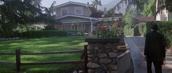 Movie still from “Poltergeist II: The Other Side” (1986), directed by Brian Gibson – A house that is in the middle of a yard; Extreme Wide shot, High angle