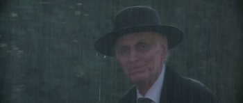 Movie still from “Poltergeist II: The Other Side” (1986), directed by Brian Gibson – An old man wearing a hat and a suit; Close Up shot, Low angle