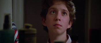 Movie still from “Poltergeist II: The Other Side” (1986), directed by Brian Gibson – A young man looking up at the sky; Close Up shot, Low angle