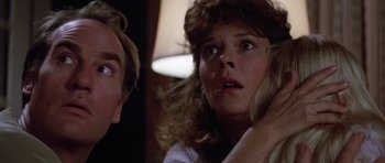 Movie still from “Poltergeist II: The Other Side” (1986), directed by Brian Gibson – A woman is looking at a man in a room; Close Up shot, Low angle
