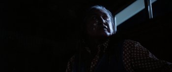 Movie still from “Poltergeist II: The Other Side” (1986), directed by Brian Gibson – An older woman with a white face paint; Close Up shot, Low angle