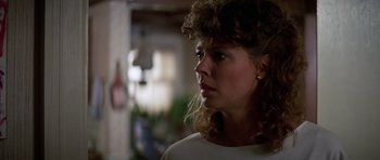 Movie still from “Poltergeist II: The Other Side” (1986), directed by Brian Gibson – A person wearing a white shirt; Close Up shot, Over the shoulder angle