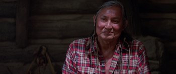 Movie still from “Poltergeist II: The Other Side” (1986), directed by Brian Gibson – An older native american woman wearing a red plaid shirt; Close Up shot, Over the shoulder angle