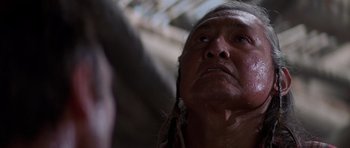 Movie still from “Poltergeist II: The Other Side” (1986), directed by Brian Gibson – An older native american man looking up into the sky; Close Up shot, Low angle