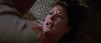 Movie still from “Poltergeist II: The Other Side” (1986), directed by Brian Gibson – A person laying on the ground; Close Up shot, Overhead angle