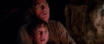 Movie still from “Poltergeist II: The Other Side” (1986), directed by Brian Gibson – A man and a boy are sitting next to each other; Close Up shot, Low angle