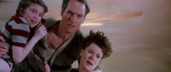 Movie still from “Poltergeist II: The Other Side” (1986), directed by Brian Gibson – A man and a woman are standing next to each other; Close Up shot, Low angle