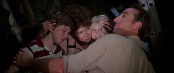 Movie still from “Poltergeist II: The Other Side” (1986), directed by Brian Gibson – A group of people that are looking at each other's faces; Close Up shot, Low angle