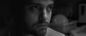 Movie still from “Polytechnique” (2009), directed by Denis Villeneuve – Black and white photograph of a man with a beard; Extreme Close Up shot, Low angle