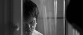 Movie still from “Polytechnique” (2009), directed by Denis Villeneuve – A man with a shaving foam on his face; Extreme Close Up shot, Over the shoulder angle