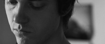 Movie still from “Polytechnique” (2009), directed by Denis Villeneuve – View of the face of a young man; Extreme Close Up shot, Over the shoulder angle