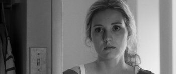 Movie still from “Polytechnique” (2009), directed by Denis Villeneuve – A woman looking at the camera in a mirror; Close Up shot, Over the shoulder angle