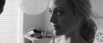 Movie still from “Polytechnique” (2009), directed by Denis Villeneuve – A woman's face in black - and - white photo; Close Up shot, Over the shoulder angle