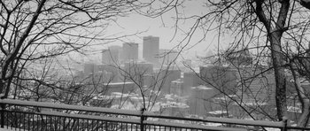 Movie still from “Polytechnique” (2009), directed by Denis Villeneuve – A black and white photo of a city in the snow; Extreme Wide shot, High angle