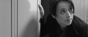 Movie still from “Polytechnique” (2009), directed by Denis Villeneuve – A woman leaning against a wall with her hand on the wall; Close Up shot, Over the shoulder angle