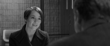 Movie still from “Polytechnique” (2009), directed by Denis Villeneuve – A woman sitting in front of a man in a suit; Close Up shot, Over the shoulder angle