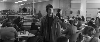 Movie still from “Polytechnique” (2009), directed by Denis Villeneuve – Black and white photograph of a young man in a cafeteria; Medium shot, Over the shoulder angle