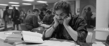 Movie still from “Polytechnique” (2009), directed by Denis Villeneuve – Black and white photograph of a man at a table in a classroom; Close Up shot, High angle