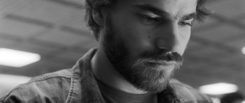 Movie still from “Polytechnique” (2009), directed by Denis Villeneuve – Black and white photograph of a man with a beard; Extreme Close Up shot, Low angle