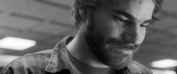 Movie still from “Polytechnique” (2009), directed by Denis Villeneuve – Black and white photograph of a man with a beard; Extreme Close Up shot, Over the shoulder angle