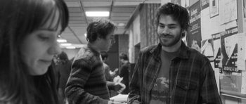 Movie still from “Polytechnique” (2009), directed by Denis Villeneuve – Two young men standing next to each other in a building; Medium shot, Over the shoulder angle