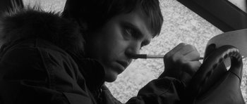Movie still from “Polytechnique” (2009), directed by Denis Villeneuve – A young man smoking a cigarette while wearing a jacket; Close Up shot, Low angle