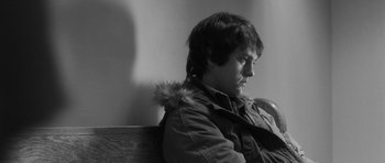 Movie still from “Polytechnique” (2009), directed by Denis Villeneuve – Black and white photograph of a man sitting on a bench; Close Up shot, Over the shoulder angle