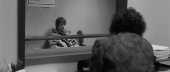 Movie still from “Polytechnique” (2009), directed by Denis Villeneuve – A man sitting in front of a bathroom mirror; Medium shot, Over the shoulder angle