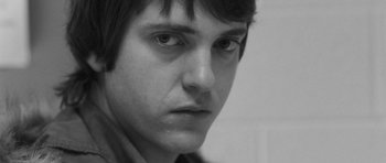 Movie still from “Polytechnique” (2009), directed by Denis Villeneuve – A person's face in a black and white photo; Close Up shot, Low angle