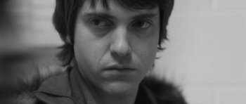 Movie still from “Polytechnique” (2009), directed by Denis Villeneuve – A person's face in a black and white photo; Close Up shot, Over the shoulder angle