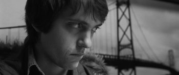 Movie still from “Polytechnique” (2009), directed by Denis Villeneuve – A man's face in a black - and - white photo; Close Up shot, Low angle