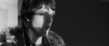 Movie still from “Polytechnique” (2009), directed by Denis Villeneuve – A young man with a fur coat is looking into the distance; Close Up shot, Low angle