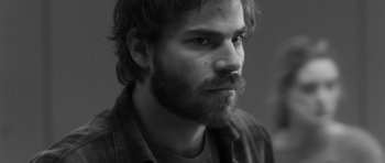 Movie still from “Polytechnique” (2009), directed by Denis Villeneuve – Black and white photograph of a man with a beard; Close Up shot, High angle