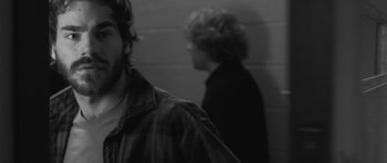 Movie still from “Polytechnique” (2009), directed by Denis Villeneuve – Two men standing next to each other in front of a brick wall; Close Up shot, Over the shoulder angle