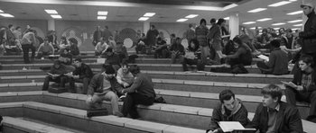 Movie still from “Polytechnique” (2009), directed by Denis Villeneuve – A black and white photo of people sitting on some steps; Wide shot, High angle
