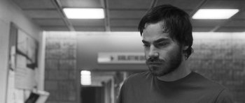 Movie still from “Polytechnique” (2009), directed by Denis Villeneuve – Black and white photograph of a man with a beard; Close Up shot, Low angle