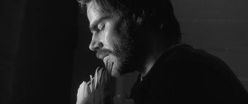 Movie still from “Polytechnique” (2009), directed by Denis Villeneuve – Black and white photograph of a man with his eyes closed; Close Up shot, Low angle