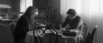 Movie still from “Polytechnique” (2009), directed by Denis Villeneuve – A man and a woman sitting at a dining room table; Medium shot, High angle