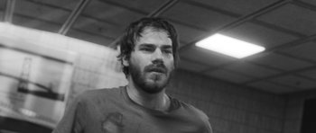 Movie still from “Polytechnique” (2009), directed by Denis Villeneuve – Black and white photograph of a man with wet hair; Close Up shot, Low angle