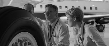 Movie still from “Polytechnique” (2009), directed by Denis Villeneuve – A man and a woman looking at something on a table; Medium shot, Low angle