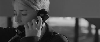 Movie still from “Polytechnique” (2009), directed by Denis Villeneuve – A person holding a cell phone to their ear; Extreme Close Up shot, Over the shoulder angle