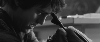 Movie still from “Polytechnique” (2009), directed by Denis Villeneuve – A man is holding a brush in his mouth; Extreme Close Up shot, Low angle