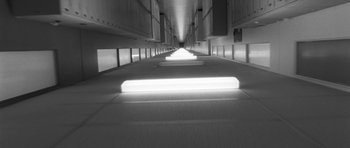 Movie still from “Polytechnique” (2009), directed by Denis Villeneuve – A long hallway with lights on both sides of the floor; Extreme Wide shot, Overhead angle