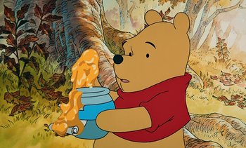 Movie still from “Pooh's Grand Adventure: The Search for Christopher Robin” (1997), directed by Karl Geurs – Winnie the pooh is holding a jar of honey; Close Up shot, Low angle
