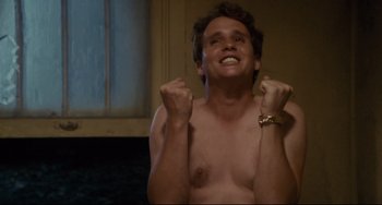 Movie still from “Porky's” (1981), directed by Bob Clark – A man with his hands up in the air; Medium shot, Low angle